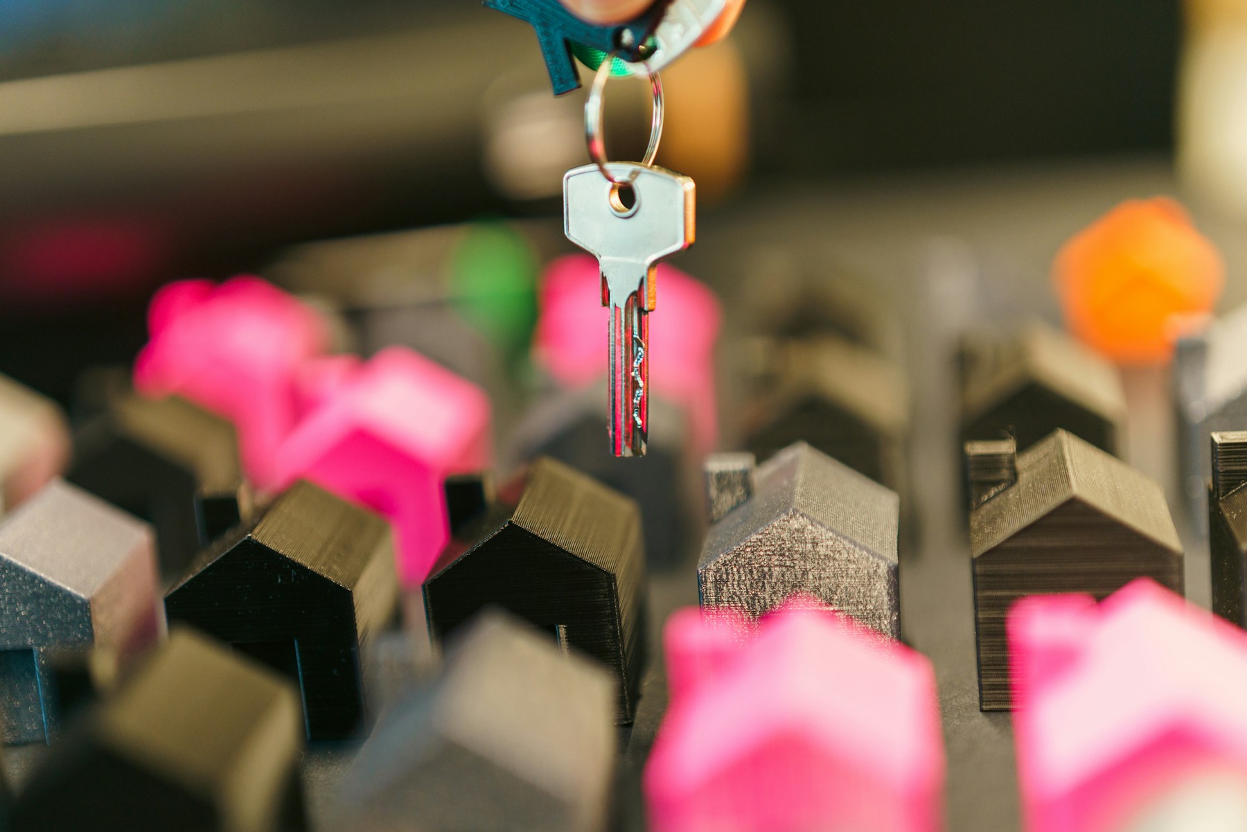 House investment concept with keys and model homes